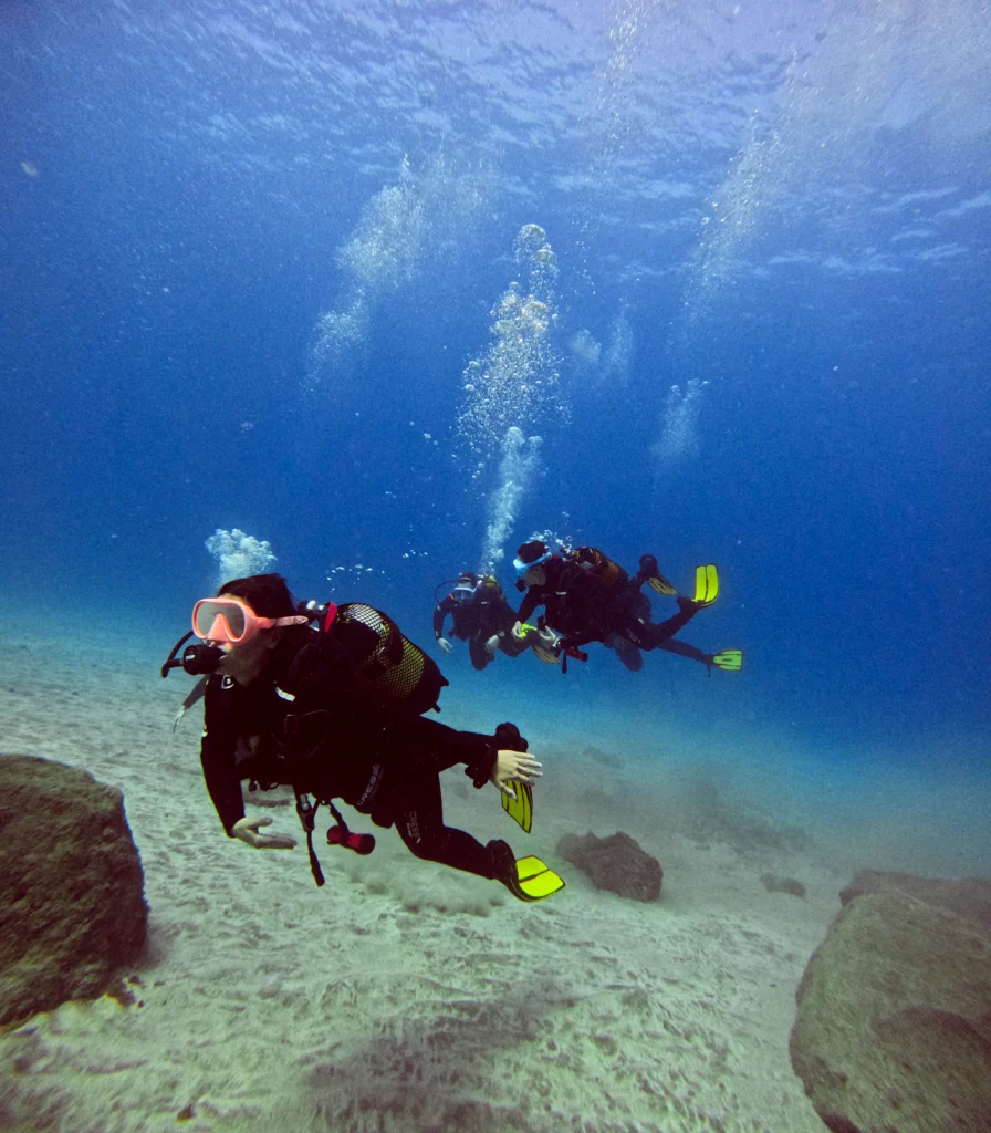 Scuba Diving in Los Cristianos: The Ultimate Guide to Tenerife South’s Best Diving Hub 1 Scuba divers exploring Tenerife’s volcanic underwater landscape in Los Cristianos, guided by professional instructors from Barbarian Diving Tenerife.
