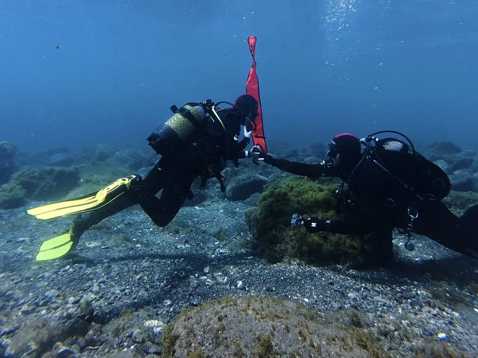 Two SSI Rescue Diver students practising underwater rescue skills with a surface marker buoy during open water dives at Barbarian Diving Tenerife